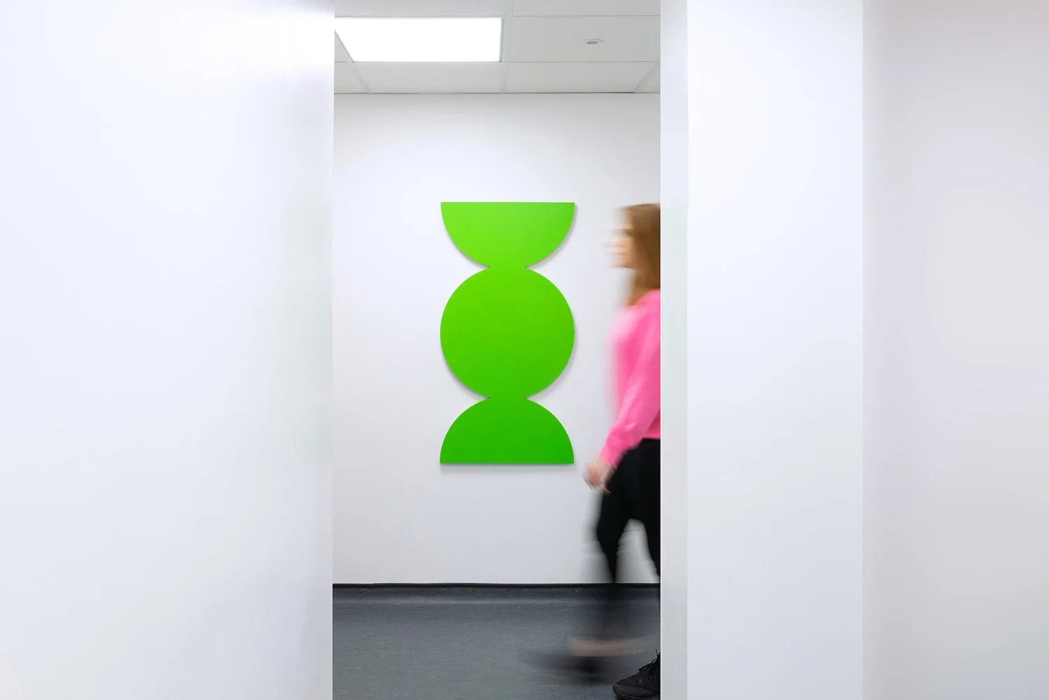 Green geometric landmark seen through a doorway