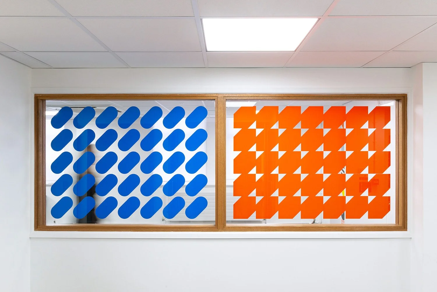 Blue and orange patterns across an interior hospital window