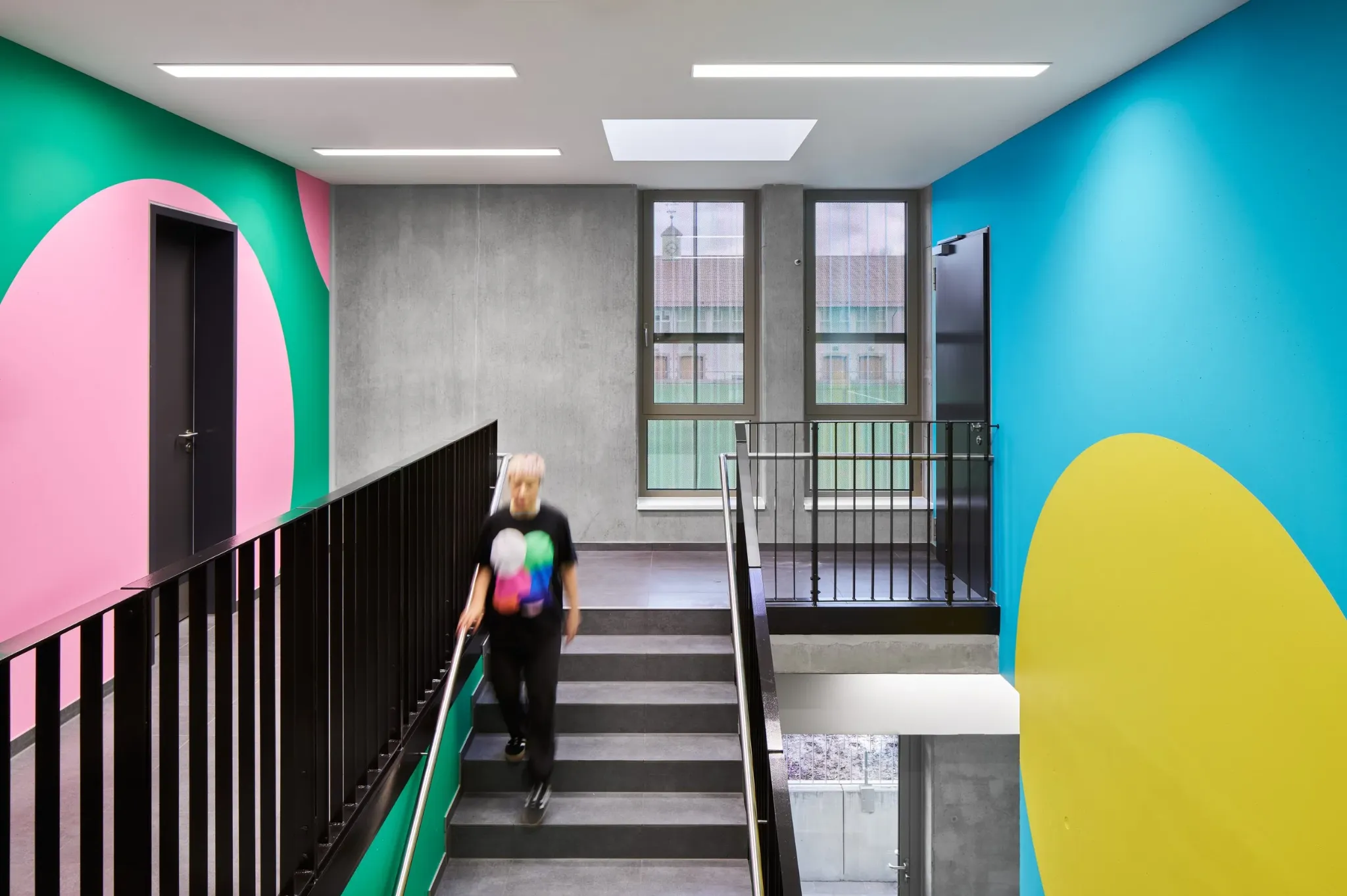 Green, blue, pink and yellow colour system in the We Play stairwell