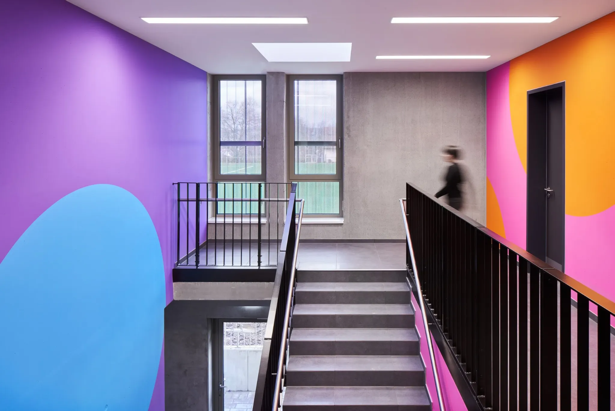 Purple, blue, pink and orange colour system in the We Play stairwell