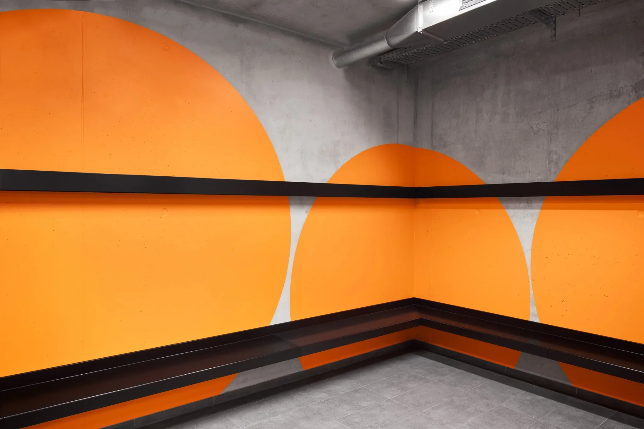 Orange circular forms wrapping around a staircase